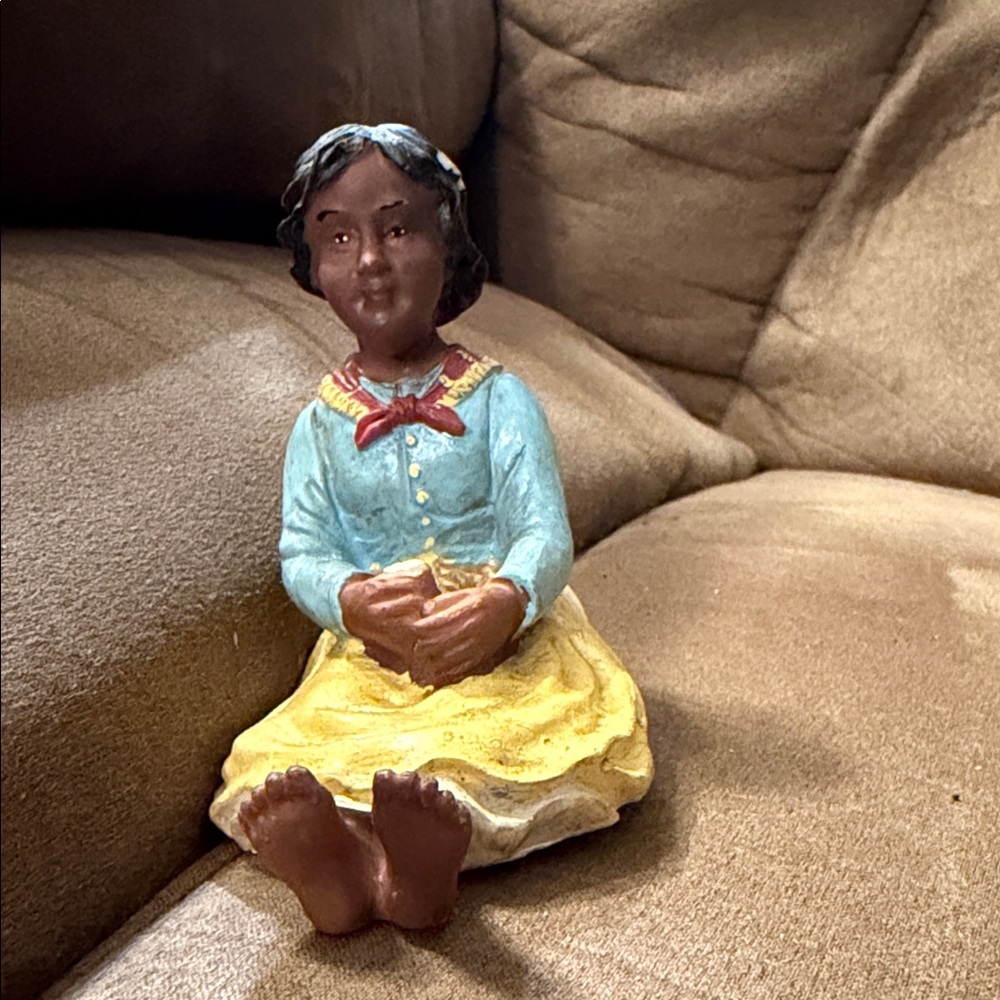 All God’s children “ Hand-Painted Seated Girl Figurine in Blue, Yellow and Brown